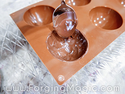 Filling hot chocolate bomb mold